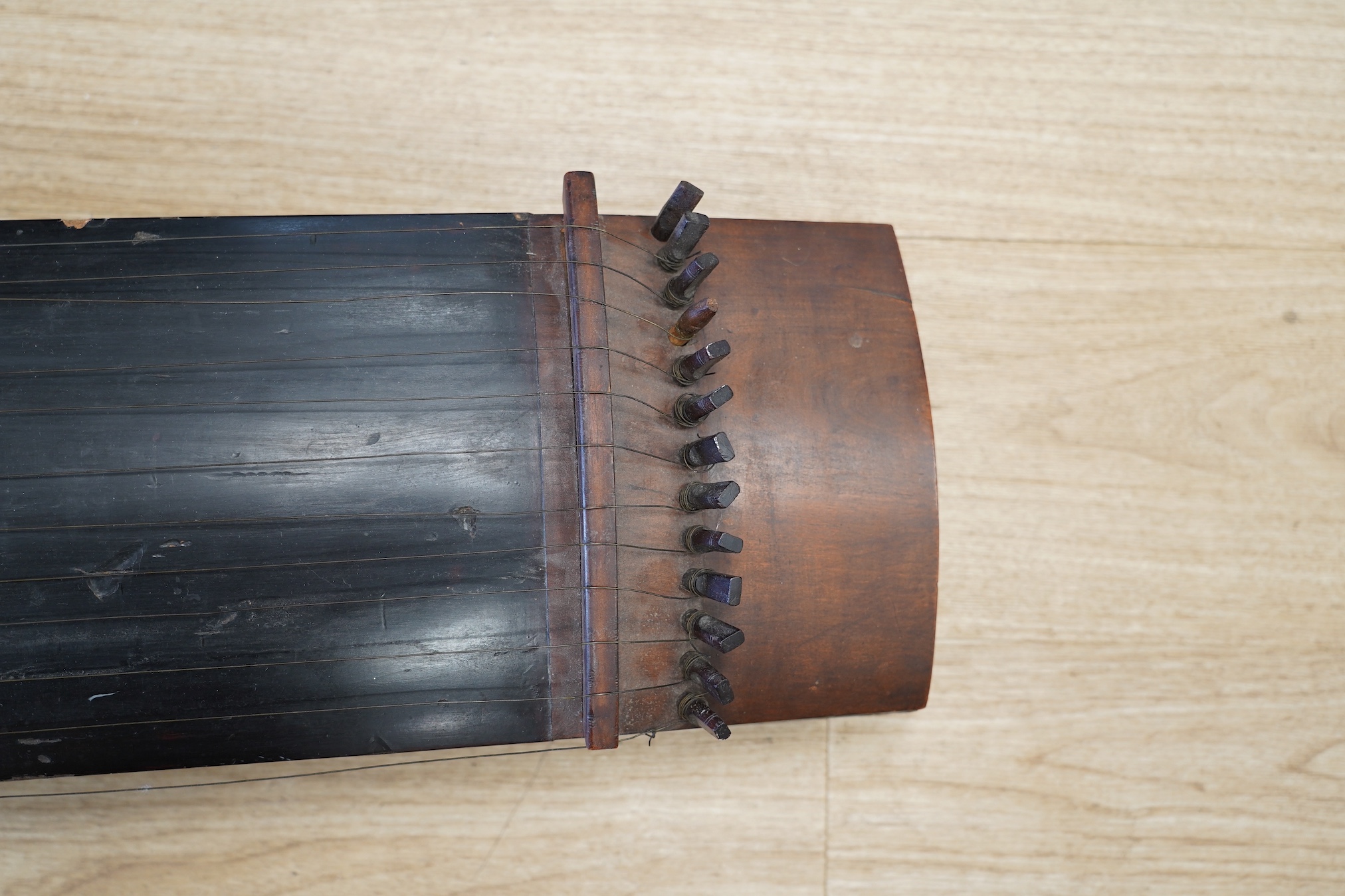 A Japanese Kato musical instrument with spares,19th century, 110cm long. Condition - fair, body of instrument and pegs have damage